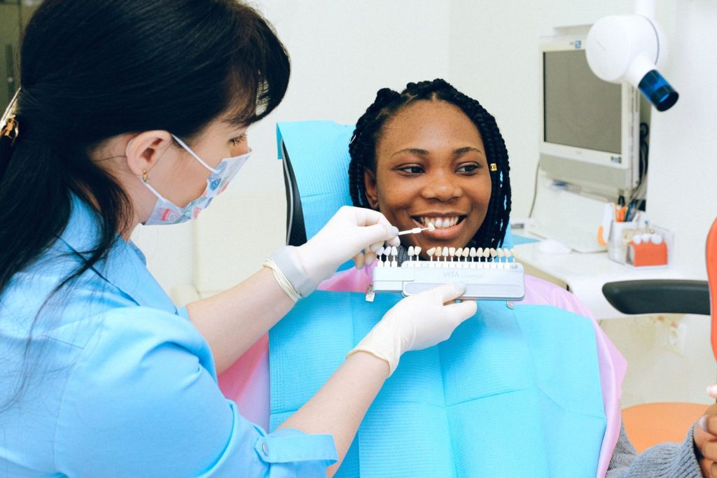 Dentist consulting a patient on veneer shades in Dubai