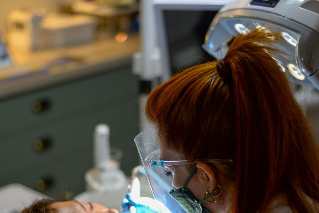 Dentist performing a procedure at a dental clinic in Dubai