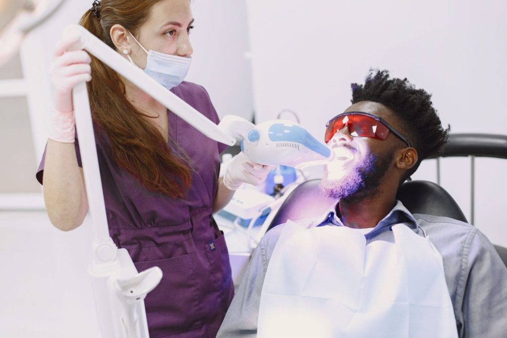 Dentist performing professional teeth whitening in Dubai