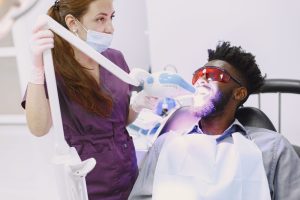 Dentist performing professional teeth whitening in Dubai